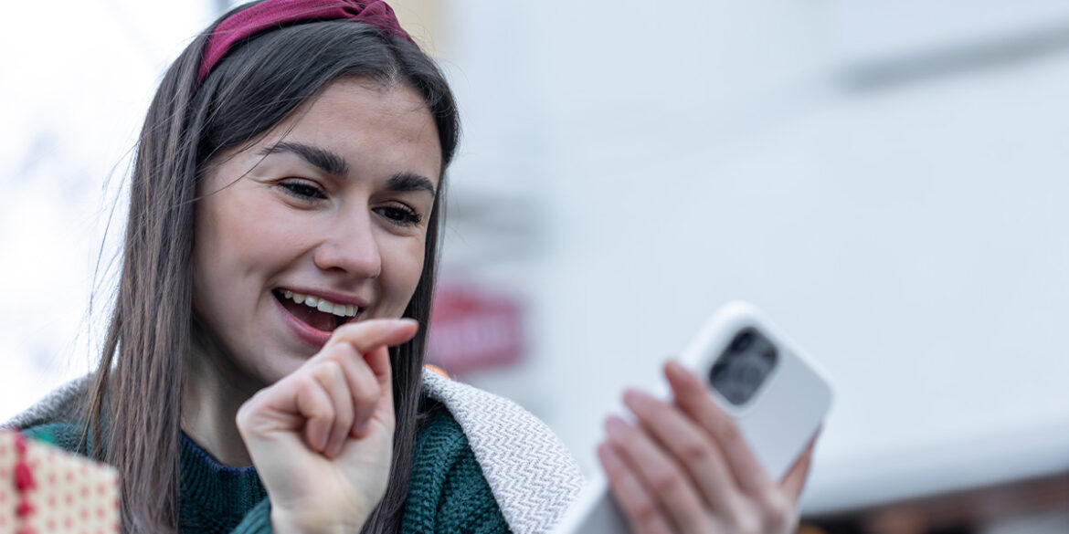 Menina sorridente e mexendo no celular